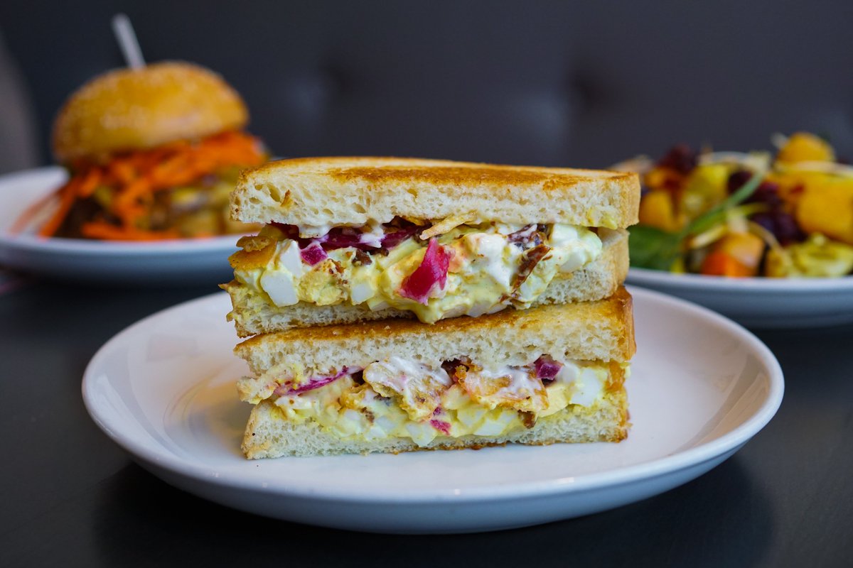 ⚠️ Warning ⚠️ This Egg Salad Sammie may cause extreme satisfaction. Crispy bacon, pickled onions, and a touch of curry elevate this classic! 🍳