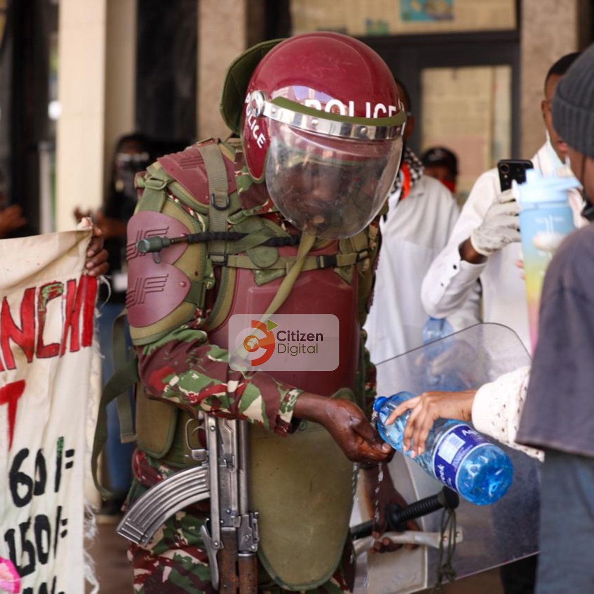 citizentvkenya's tweet image. Nairobi: Protesters assist a police officer during the Anti-Finance Bill demos