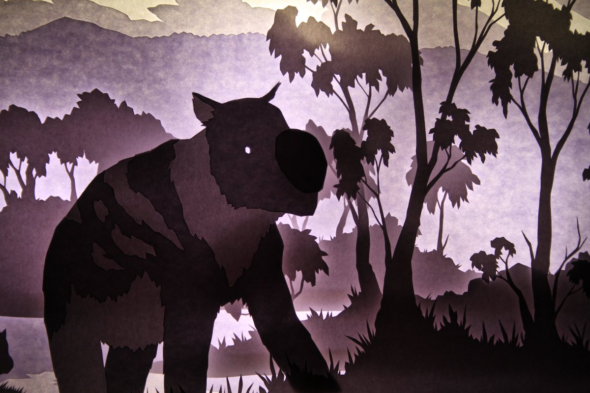 idrawsdinosaurs's tweet photo. New lightbox #paleoart featuring #Diprotodon optatum, the largest known marsupial to ever live! Made using watercolour paper and printer paper cut with a scalpel. First time I've tried mixing different paper types, they give a lovely contrast of warm and cool tones when lit up! https://t.co/p8zW1UPZTQ