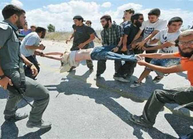 THIS IS ZIONISM 

Settlers trying to tear a Palestinian child apart.
