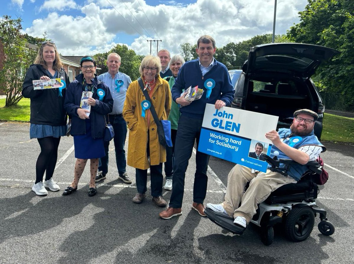 LNevilleRolfe's tweet photo. Glad to be out with @JohnGlenUK in his new patch in my native #Nadder Valley. Sheltering together from the rain in a classic local stone bus shelter. Pleased to be in the #Salisbury constituency and to keep supporting the market and the shops. https://t.co/p0D7jd9uUg