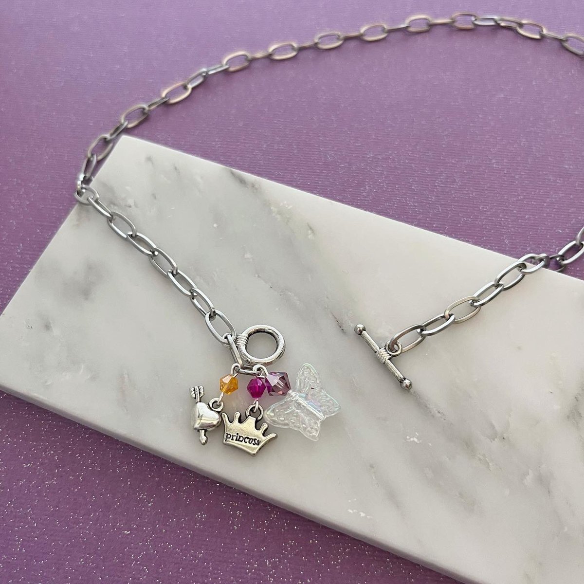BombDotComShop's tweet photo. Chappell Roan + y2k + pride month = this sapphic magic butterfly mini collection 🥰 a percentage of all my pride jewelry goes towards charity all year round! https://t.co/RaAfN0VntD