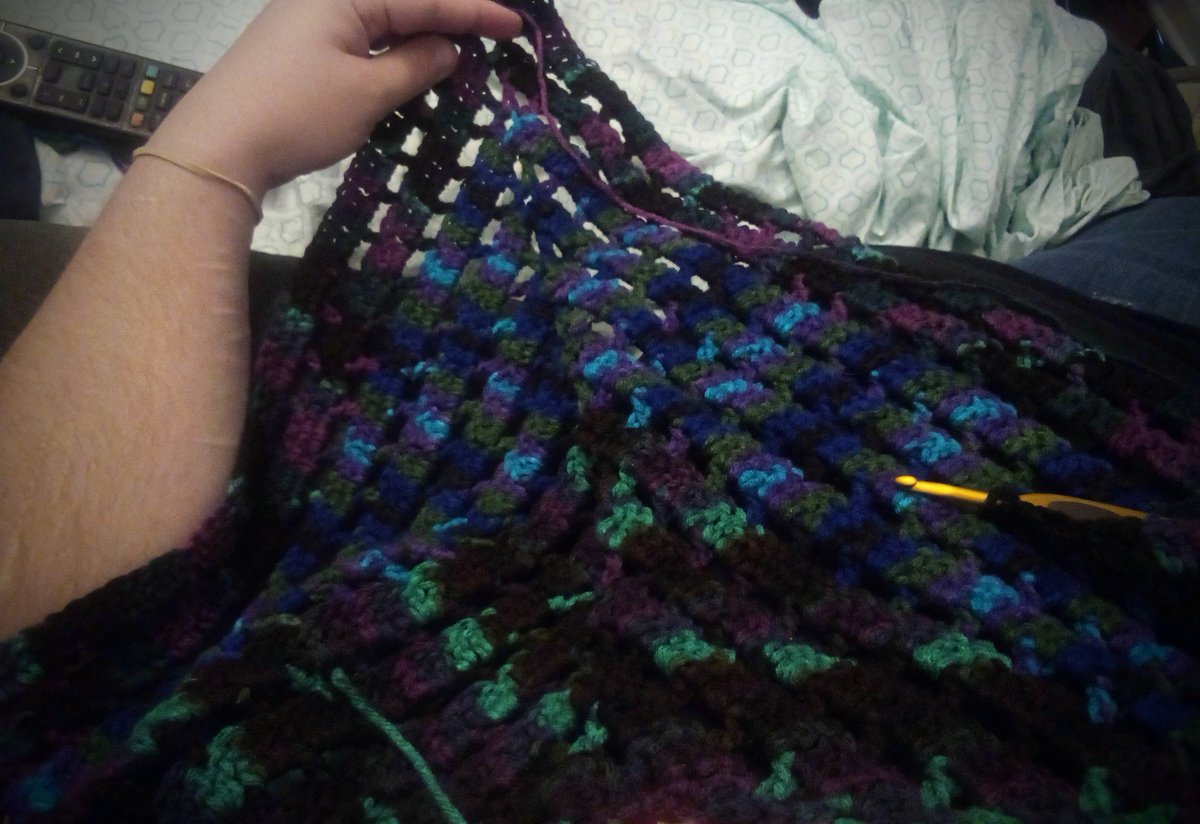 UnHaplessLarry's tweet image. I have a ton of random balls of yarn that's been "rescued" from various places and many of these colors are out of print, so I'm making a scrap shawl with a bunch of it.  Triangle shaped because triangles are cool 😎