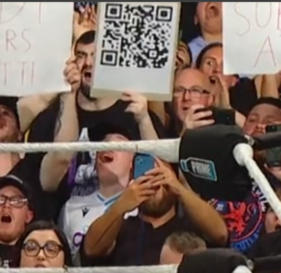 SubToSlamX's tweet photo. Shout out to this guy holding up a Rick Roll QR code 😂

#WWECastle https://t.co/JpKX1lT9BE