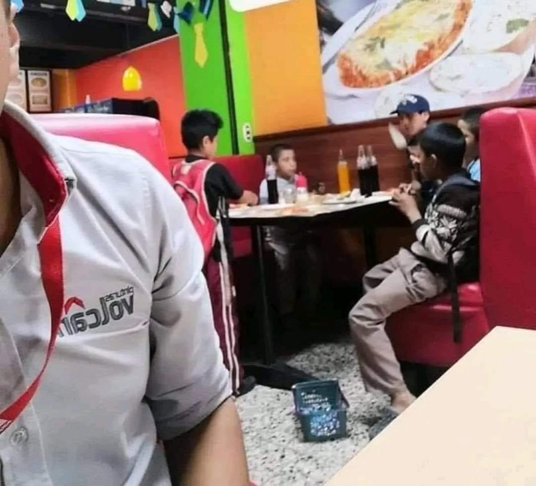 Un grupo de niños hicieron una vaquita para poder comprar una pizza y un plato de alitas, lo estaban disfrutando, cuando entró el niño de suéter negro con blanco a vender dulces, mi sorpresa fue cuando lo invitaron a que se sentara a comer con ellos sin conocerlo. Digno de