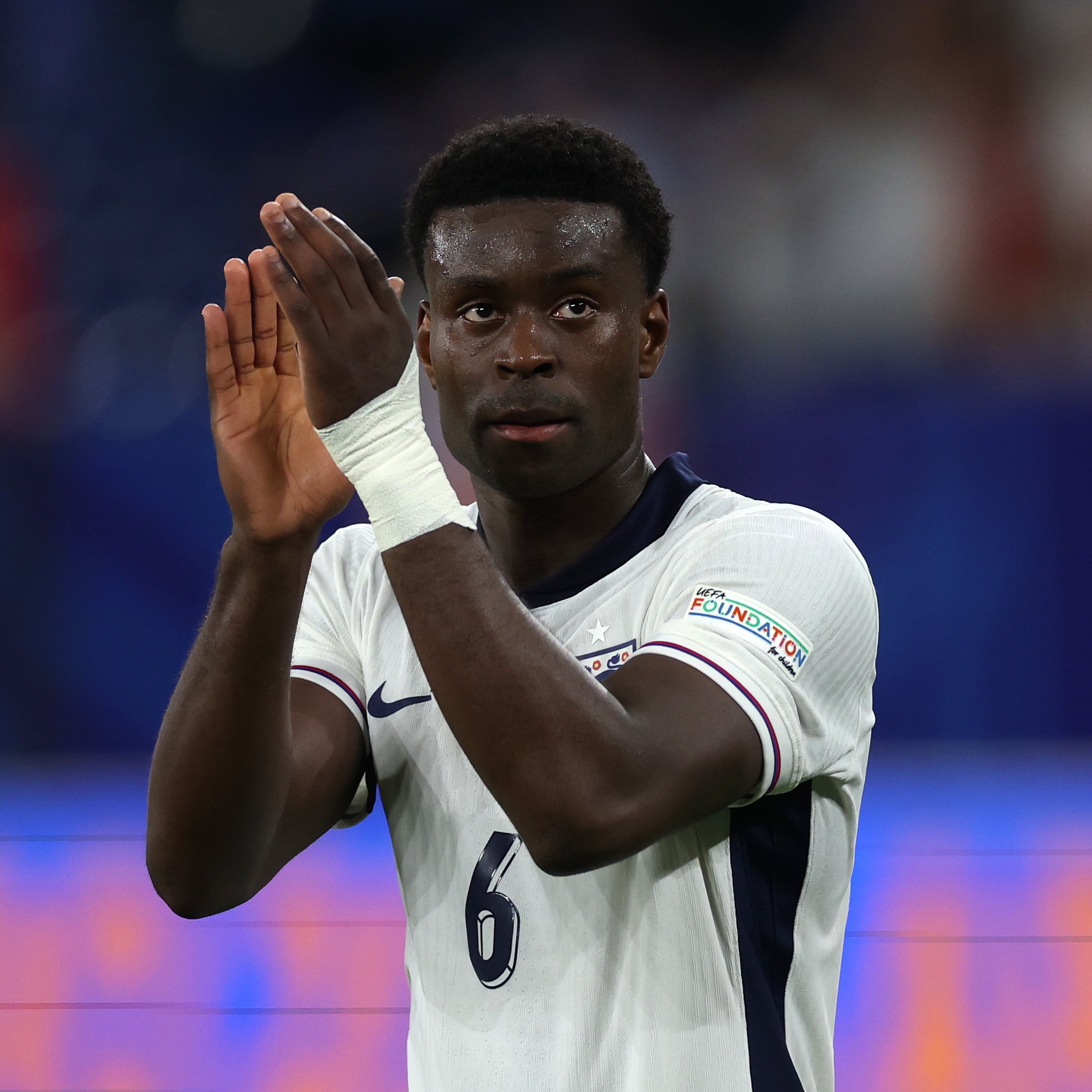 Marc Guehi applauds England fans after Serbia win.