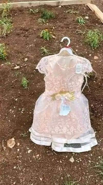 xyzveiws's tweet photo. A Palestinian father leaves Eid clothes on his daughter's grave (8 year's old) https://t.co/UbH5JdcwJu
