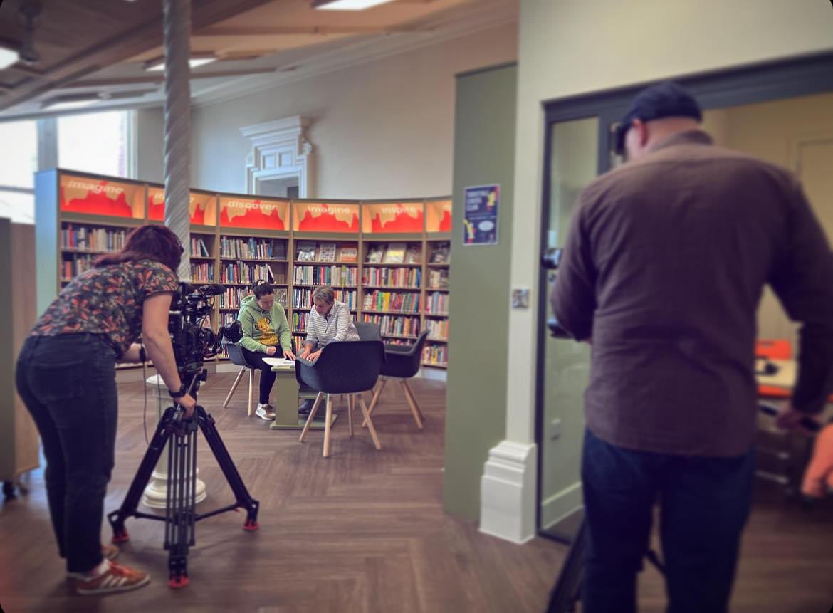 Read_Easy_NS's tweet photo. The BBC One Show this evening (Mon. 17/6) will have a feature about Read Easy.  Our reader Sharon and her coach Brenda are taking part.  Here's a pic of the filming taking place in Tunstall Library. https://t.co/o0iMS2nIZ2