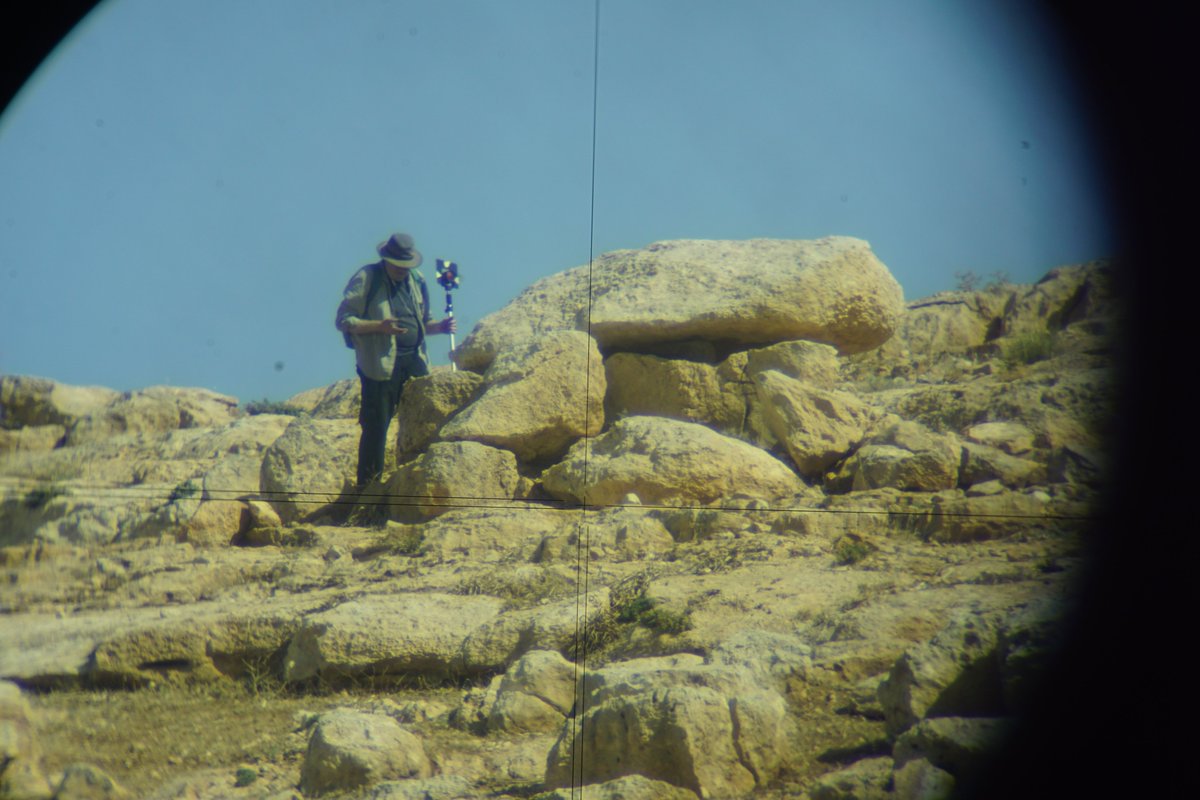 Surveyor, Silvio, photographing student, Ken, through the Total Station while measuring dolmens. We are in the process of checking through our data.