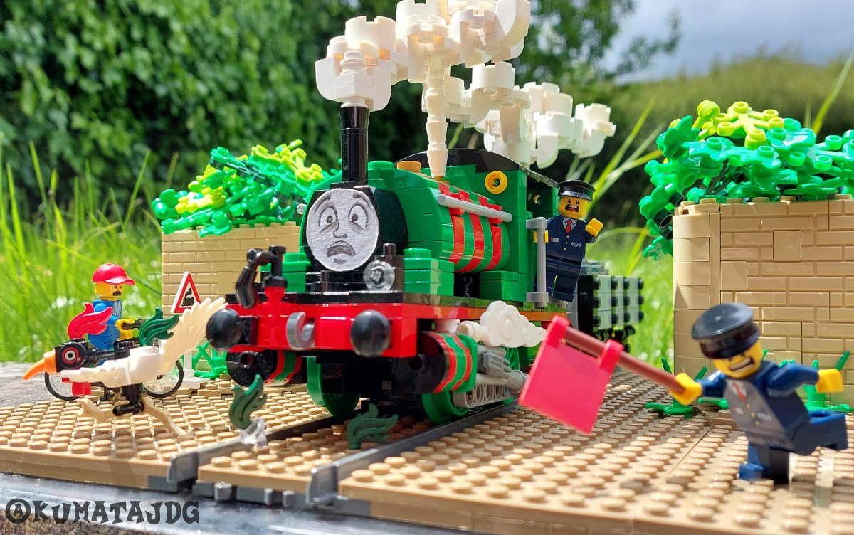 KumataJDG's tweet photo. "The man on duty at the street crossing rushed to warn traffic with his red flag, but was too late to switch Percy to the runaway siding. A slow-moving cockerel lost his tail feathers as Percy thundered across..."

My entry for the #JustLikeAwdry diorama challenge! https://t.co/GslVrt1r15