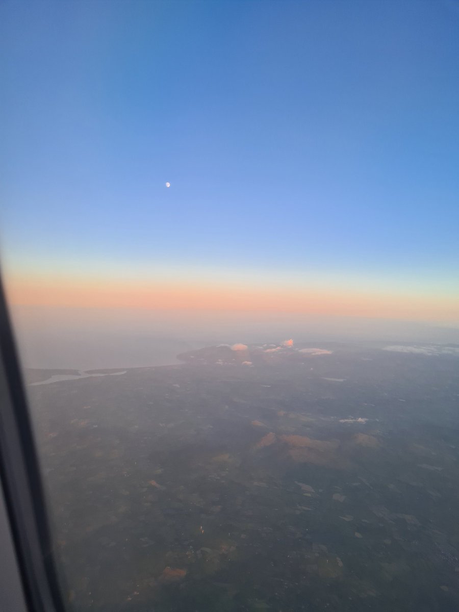 BeagonP's tweet photo. The Moon over Dundrum and  Newcastle Bays and fluffy cloud-topped Mournes, as seen from the 9.20 pm flight from Belfast International to Mamchester this evening. https://t.co/hGzw9EKU0w