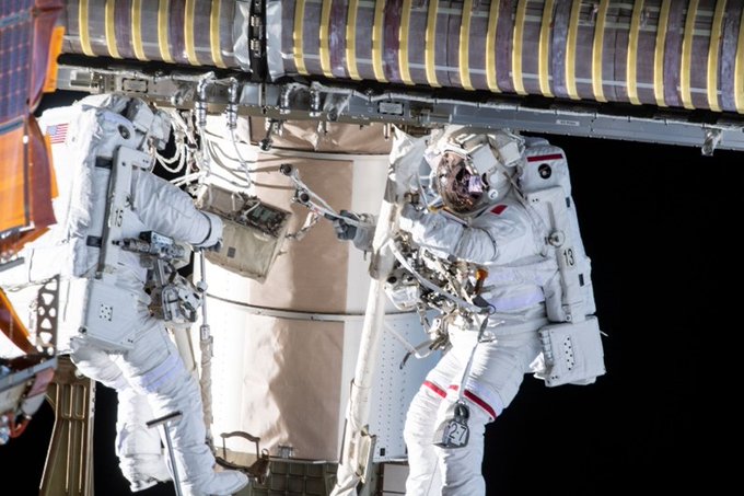 Astronauts pictured completing an installation outside of the International Space Station.