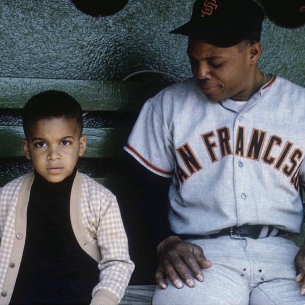 A young Barry Bonds with Willie Mays