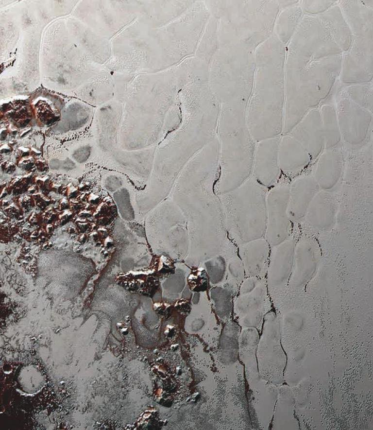 Aerial images from space of Pluto's frozen methane (CH4) capped mountains