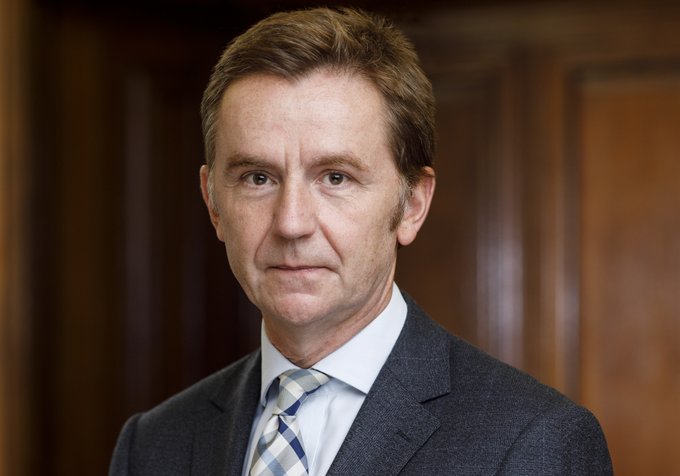 Photo of Ian Jeffery. Man with brown hair wearing a blue suit, white shirt and white and blue patterned tie.