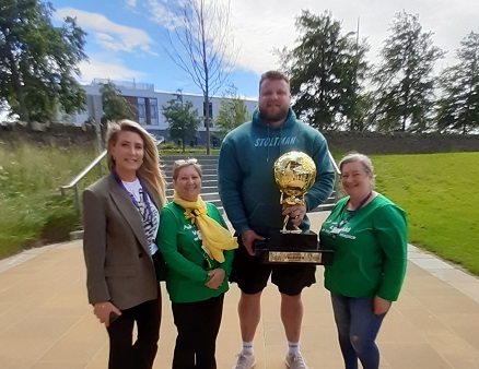 The KX Team's Last Aid Development Officer, Susan Speke, grabbed a great photo yesterday. Susan (showing the real-life size of that trophy!) and our <a href="/HighlandHospice/">Highland Hospice</a> colleagues were 'staying spicy' at <a href="/UHI_Inverness/">UHI Inverness</a> with Tom Stoltman, Worlds Strongest Man for the 3rd time.🏆