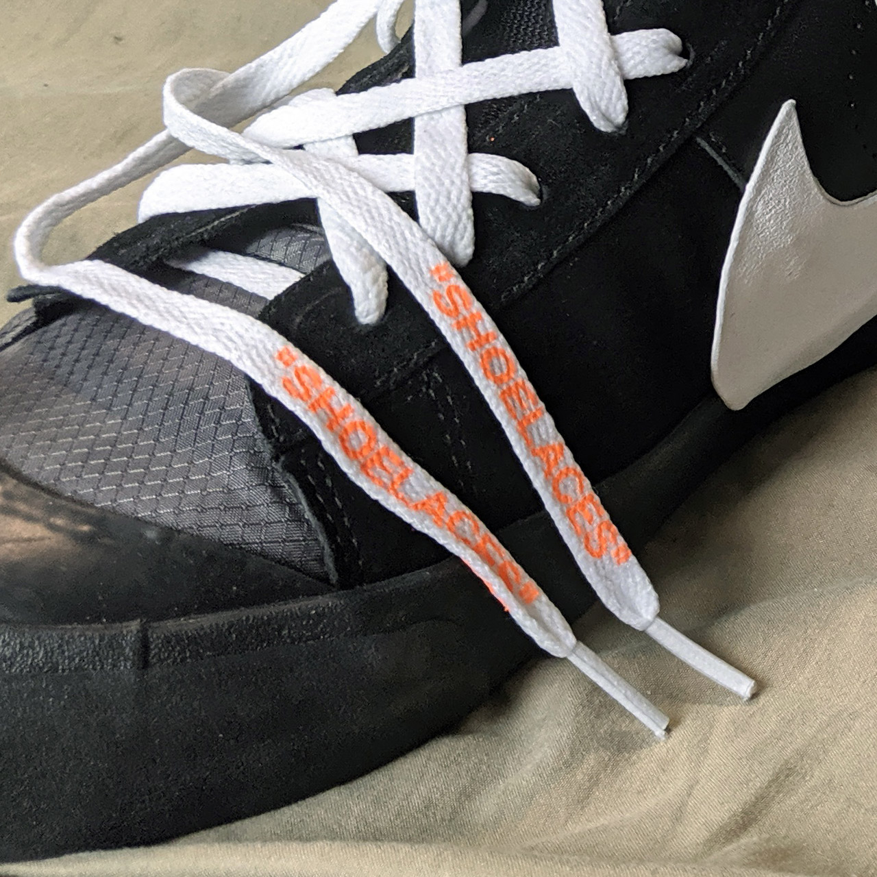 Black nike shoes with orange laces sales