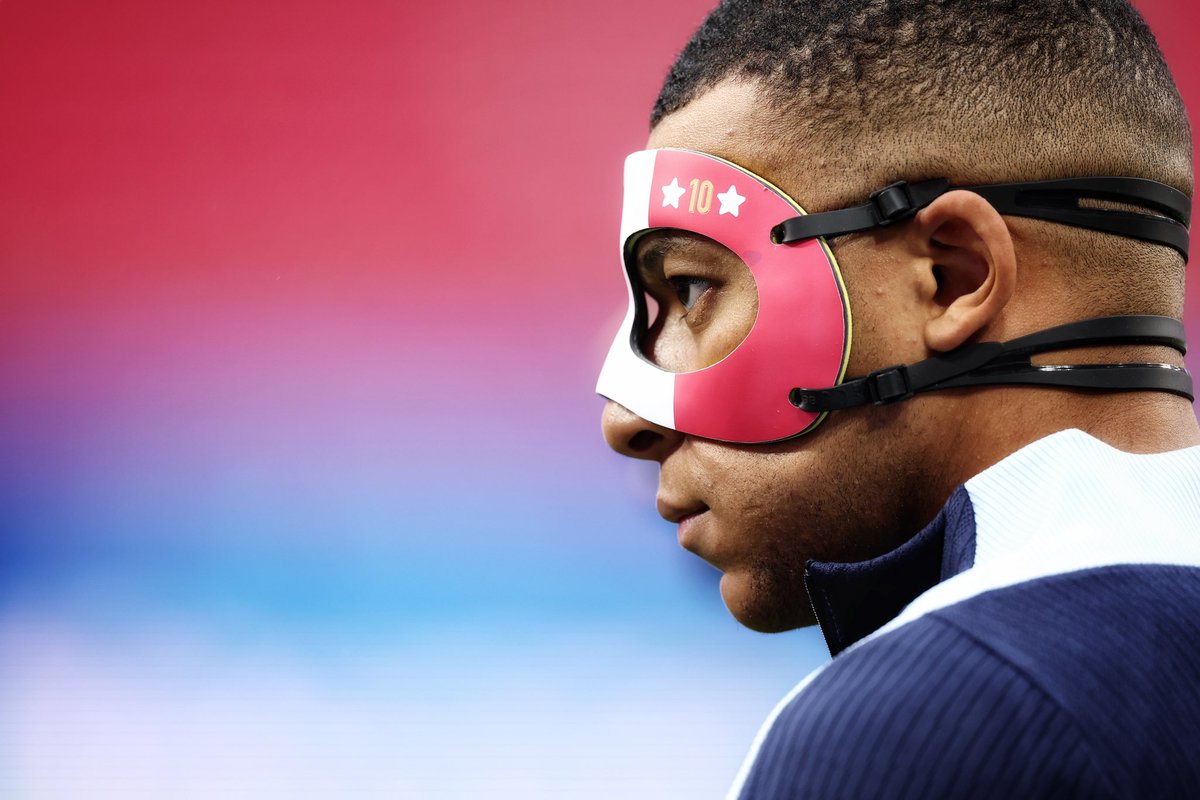 France's forward #10 Kylian Mbappe arrives wearing a face mask to take part in a MD-1 training session at the Leipzig Stadium in Leipzig, on the eve of their UEFA Euro 2024 Group D football match against Netherlands.
