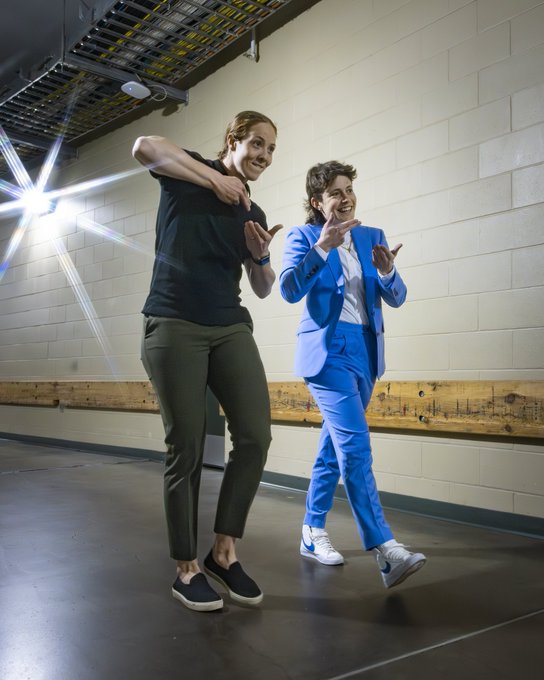 A photo of Erica Howe and Carly Jackson signing “more soup”.