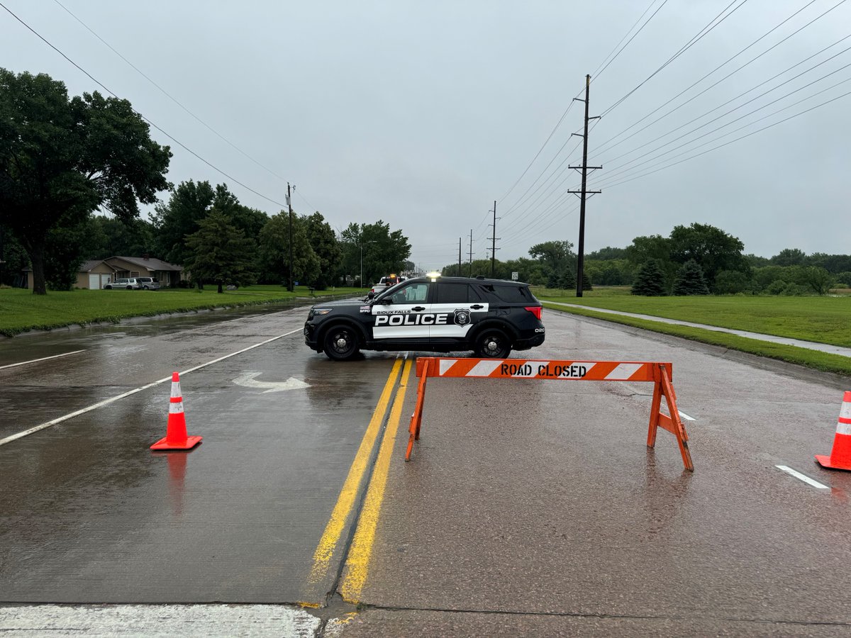 siouxfallspd's tweet photo. Flood water from Skunk Creek is over the roadway on West 12th St. The portion of 12th St / Hwy 42 from Sertoma Ave to LeMesa Drive is closed.   /713 https://t.co/ff6xJnY242