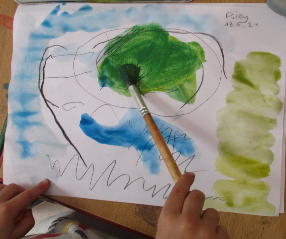 Watercolour painting is a vibrant way to extend imagination. 
"I made a frog and this is the lily pad. That is his feet and the other one. This is the lily pad and this is the water."