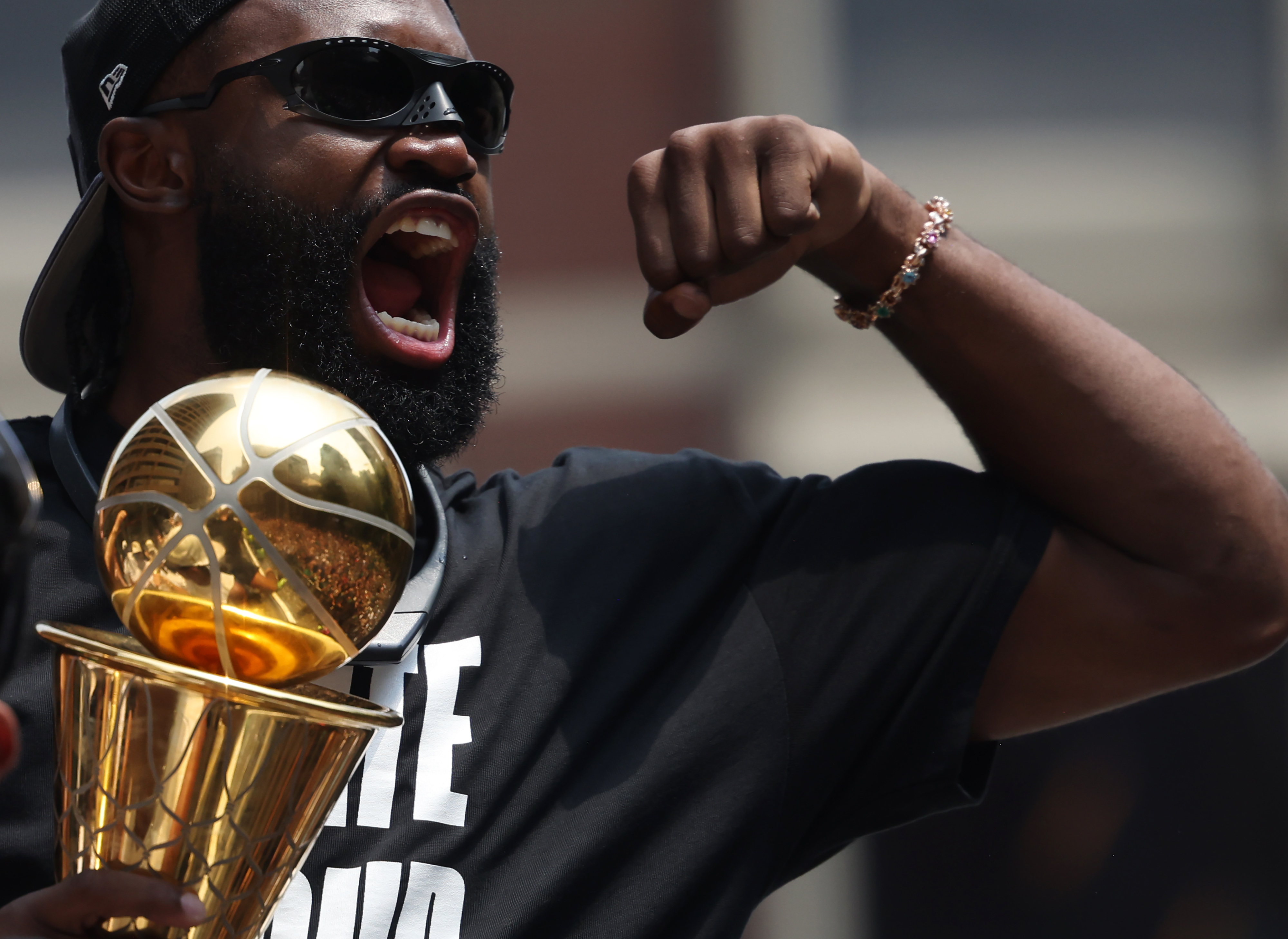 Jaylen Brown holds up the trophy while in the duck boat parade for the 2024 NBA Champion Boston Celtics.