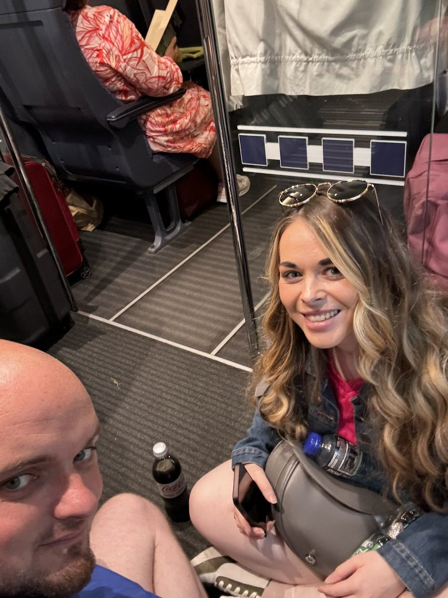 KrisWales7's tweet photo. Further update: everyone on a train that they decide to change at the last minute and swap with another train. Everyone piles off their respective trains and tried to pile on the other one. Now on a floor for 2 hours. Second picture is my German Train face! https://t.co/WltUPITuTz