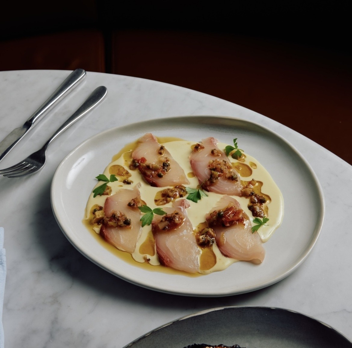 <a href="/SpencerGulfKing/">Spencer Gulf Kingfish from South Australia</a> Crudo with almond, confit fennel &amp; tomato.
🌱🌱🌱

Raw sliced Yellowtail on an almond-based sauce, topped with a confit fennel salsa including smoked dried cherry tomato, caper, green olive, and slice guindilla. 

By Nomad, Melbourne.