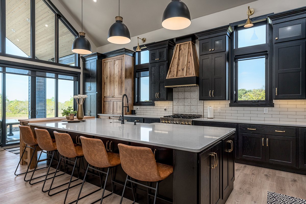 What do you think of this Swedish Cottage design, featuring striking black cabinetry paired with warm hickory Cashew accent cabinets? <a href="/Showplace_Cab/">Showplace Cabinetry</a> Pendleton door Red Oak | Black Hickory | Brushed Vintage Cashew