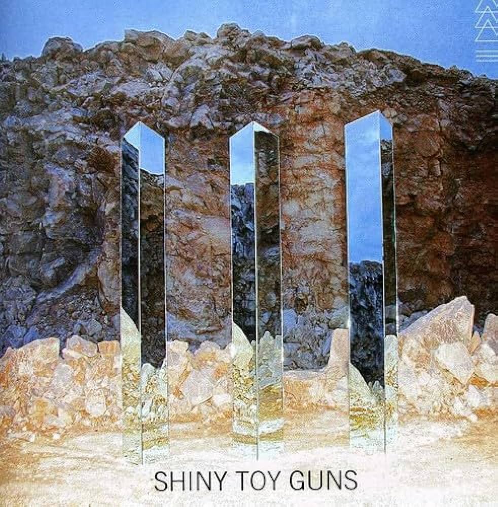 Is this not the work of Benjy Russell? I’m lookin’ at you <a href="/shinytoyguns/">SHINY TOY GUNS</a> 👀