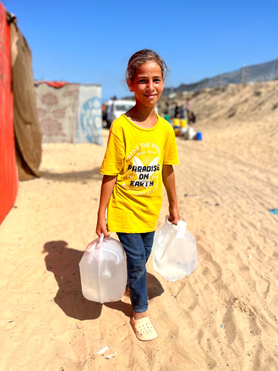 Paradise on Earth…fading. Every picture many details. How long the walk. Whose shirt? And the photographer who insists that they smile.