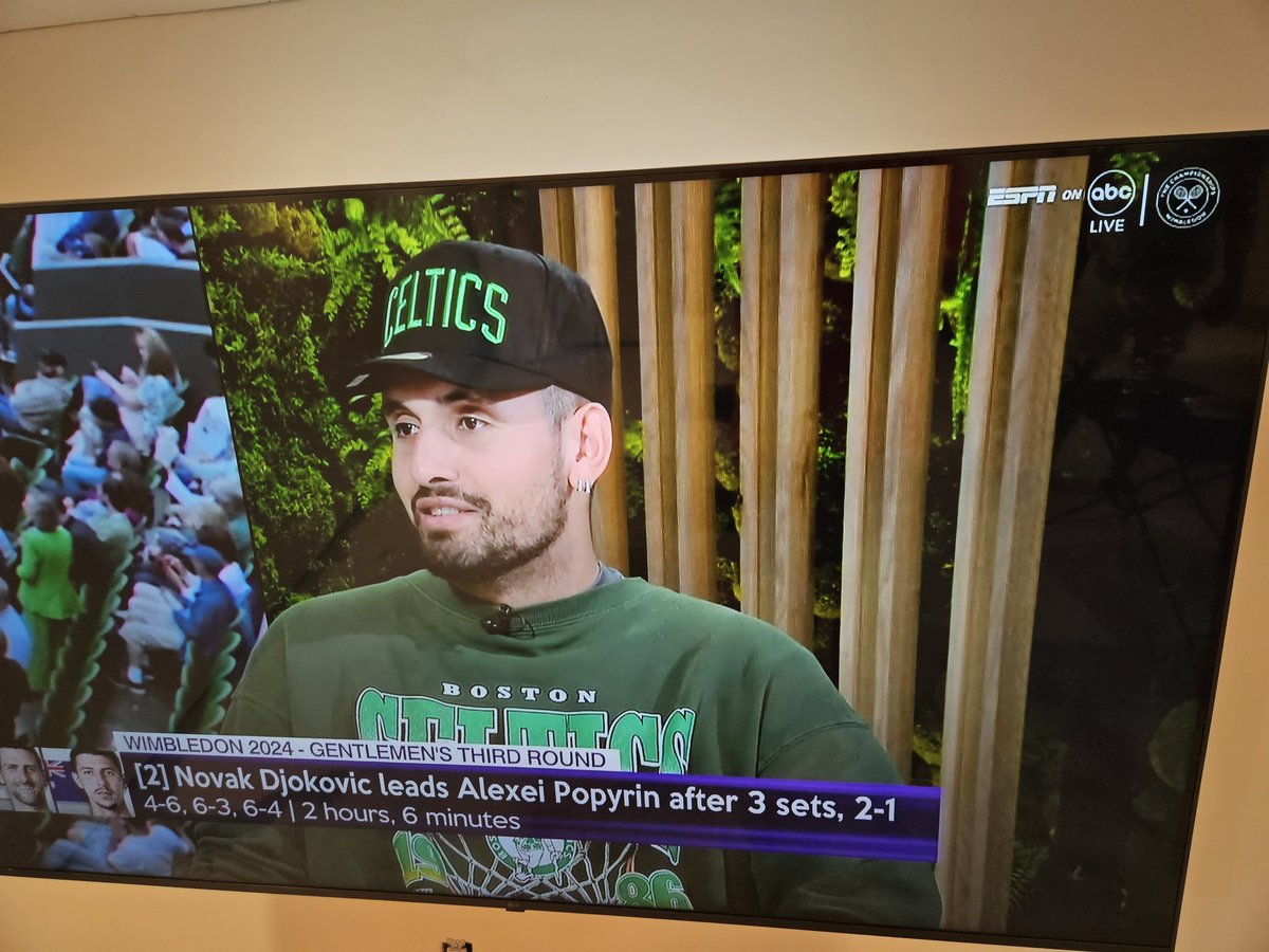 Nick Kyrgios is appropriately dressed for a Wimbledon broadcast