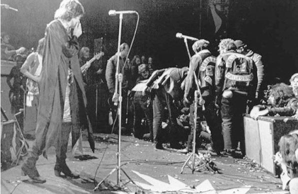 12. Mick Jagger stops the concert and looks at the Hells Angels, bikers who hired for the safety of the event, at Livermore Altamont Rock Festival. These were paid with $500 in beer. (1969)