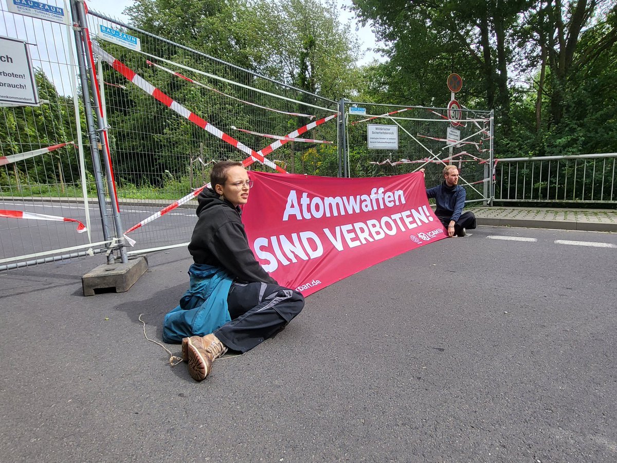 Marvin_M_'s tweet photo. To celebrate 7 years of the adoption of the TPNW, yesterday activists temporarily blocked 7 gates of the Nörvenich airbase. This is where the airplanes responsible for nuclear sharing in Germany are currently stationed. #nuclearban https://t.co/8jzffNAdZl