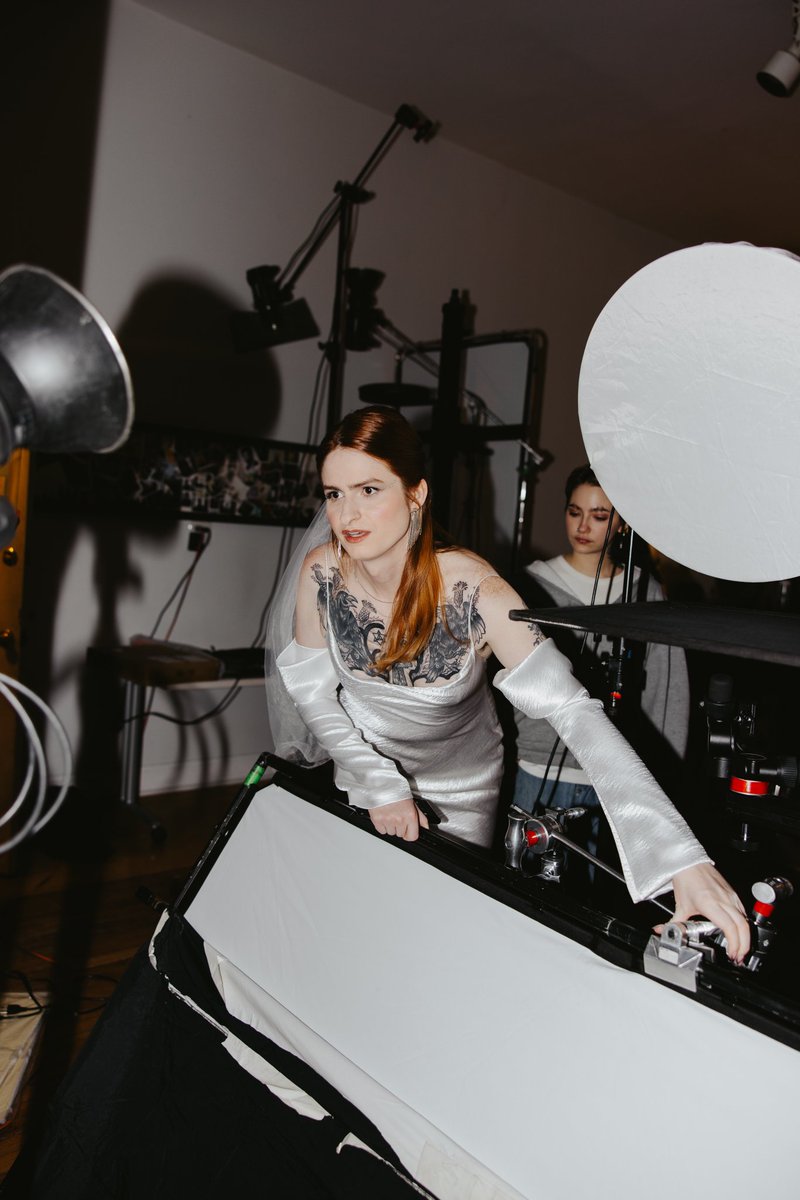 This candid of me setting up studio lighting in my wedding dress is iconic tbh