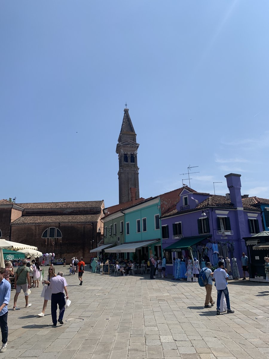KevinJamesHunt's tweet photo. The beautifully painted houses and the leaning clock tower of Burano, Italy! There was a challenge where you had to find a house that matched the color of your shirt and I think I nailed it. #burano #italy #travel https://t.co/j1hU5xEMxP