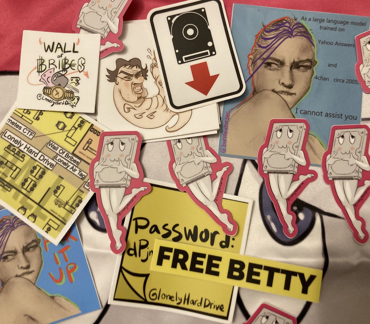 Back by popular demand, the Betty stickers and THE BODY PILLOWS! Big thank you to the artist/puzzle-maker <a href="/burninatorsec/">burninator Lonely Hard Drive @ DEFCON & @ HOPE</a> / Erica who is back again this year with her designs, contests, and more (plus some new ones not shown…!) 
 <a href="/defcon/">DEF CON</a> #defcon32 #defcon