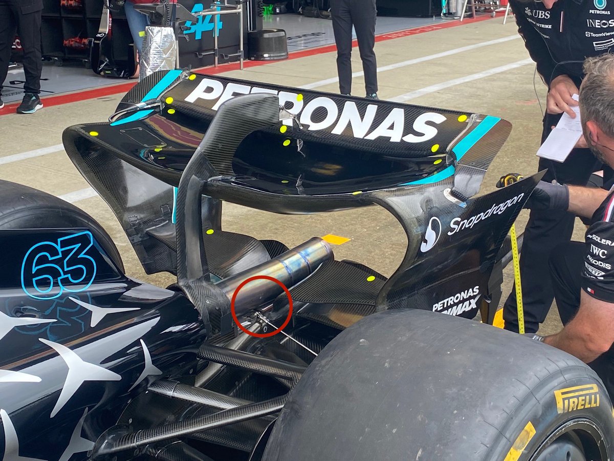 F1Techy's tweet photo. According to Franck Montagny , McLaren used a trick consisting of attaching the rear fixings of the floor to the exhaust, in order to exploit the heat emitted by it to expand the carbon and thus improve performance.

let me tell you mainly about this trick, it’s not about expanding, but more about conducting the heat to the diffuser which Lowers the air density and raises viscosity,   It will help creating a lower pressure in the diffuser and faster flow across the throat.

Look at the pictures below McLaren actually fixed the clips on the exhaust.

Red Bull has its attachments on the rear crash box.

Mercedes also attached its attachments to the crash box, but closer to the exhaust.