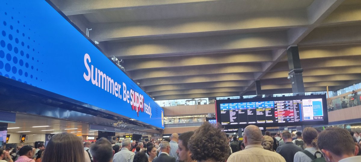 atharvai's tweet photo. @NetworkRailEUS @nationalrailenq seems like the displays need to be swapped. Useful information is on a tiny board and not readable from distance and distracting ads are huge and readable. 
Someone forgot this is a train station and not an advert station. https://t.co/Z25zU5Sig3