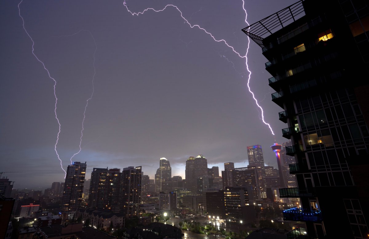 Calgary Tower strike this evening!

What is special is that this is an *upward* flash, along with the other two on the west end of downtown. 

#yyc #abstorm