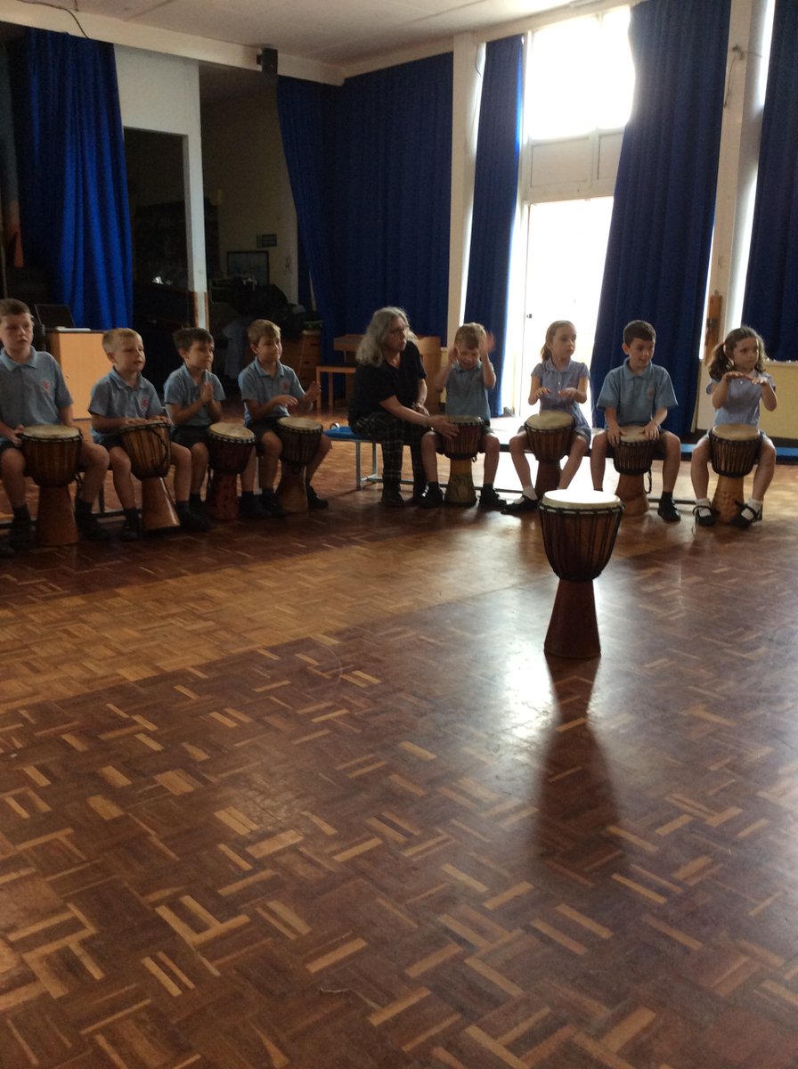 AppleySaintsCE's tweet photo. #ABASY2 concentrating hard to play the djembe drums. Here they are practicing their dun and their ka! @WorldMusicDays @WN6_Mums @StandishVoice @WigToday @FriendsPrimary https://t.co/ncYgtX650M