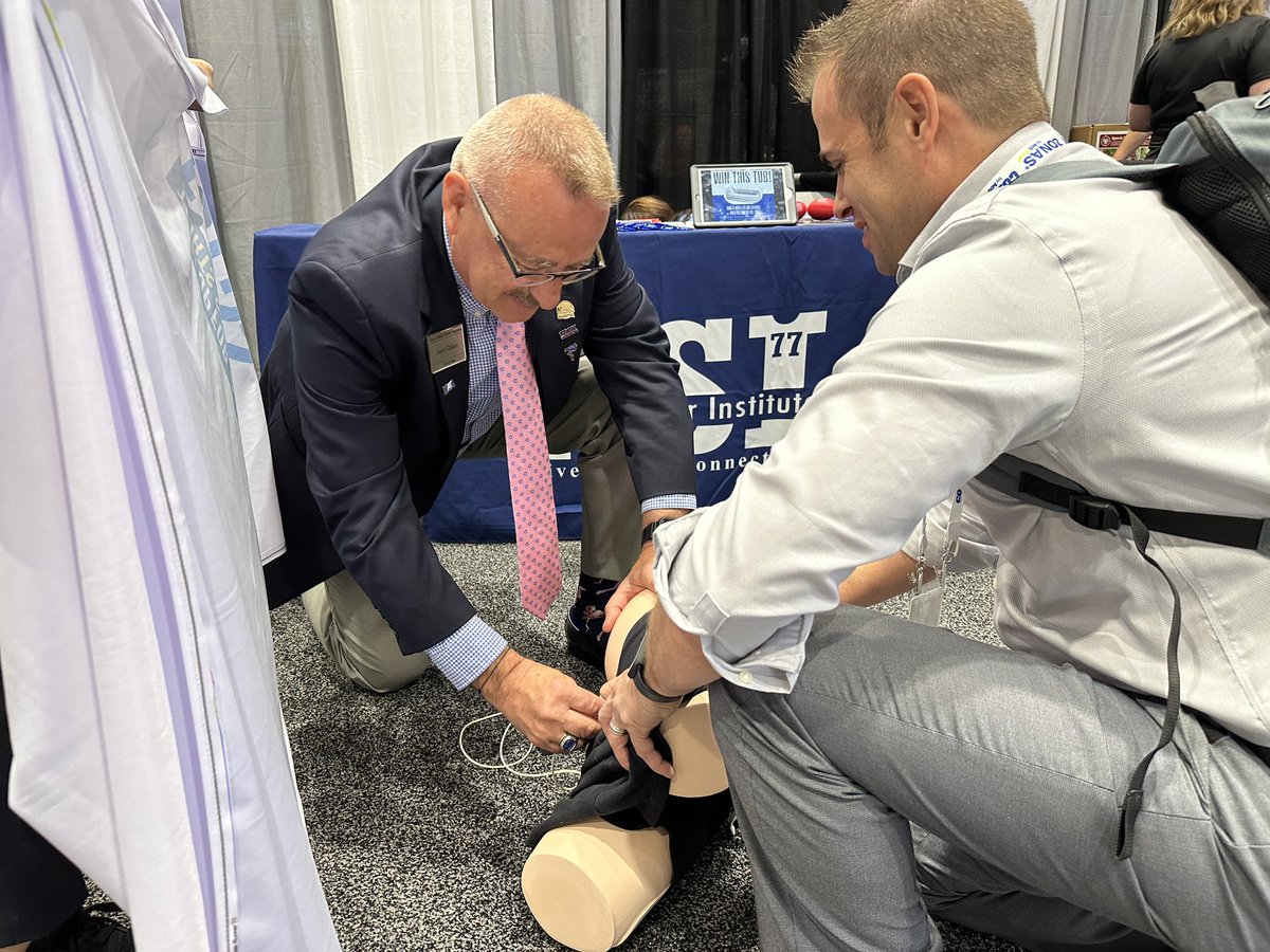 At the <a href="/K_S_Institute/">Korey Stringer Institute</a> booth learning how to insert a rectal thermometer probe. 

Even Hall of Fame SSATC alumni need to practice sometimes.