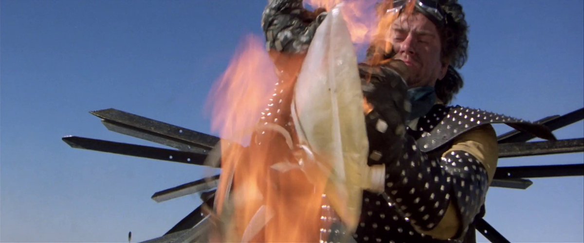 A thread about a rarely discussed point in George Miller's cinema: What the heck is this obsession with piss (and poop a little too) !?
First, Mad Max 2... the Mechanic tries to put out the fire on his legs with his urine bag