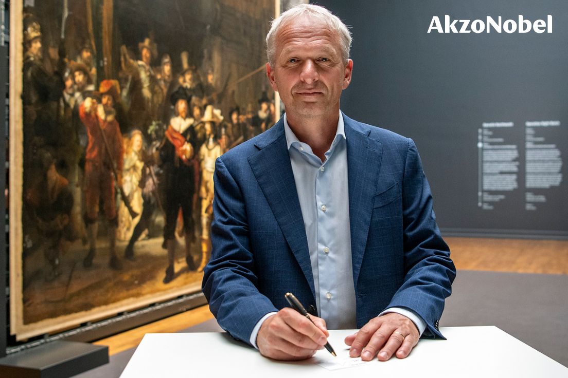 AkzoNobel's tweet photo. Honored to be a permanent part of The Night Watch. Our CEO put a sticker with his signature on the painting’s new backing board, along with a handful of special invitees to the @rijksmuseum. As a main sponsor of #OperationNightWatch, we’re now written into the artwork’s future. https://t.co/LBhg5rX5dy