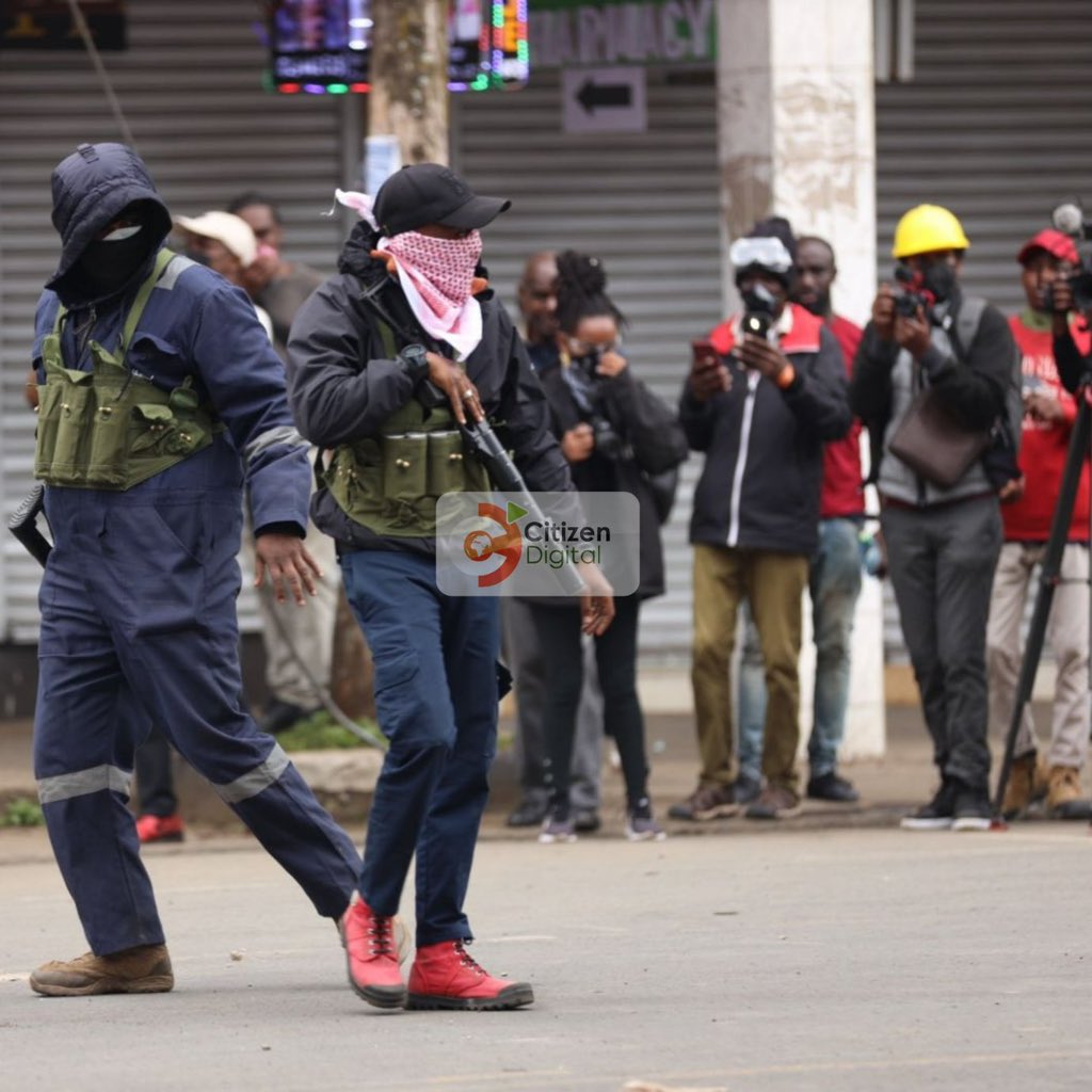 AdamMaina_'s tweet photo. “Kenya Police Service”

— Dressed and covered like militias
— Dressed in US Flag branded regalia
— Driving in unmarked pick-up trucks
— Killing unarmed civilians and kids

If they're who they say they are, why not step out in the official and designated uniforms like military. https://t.co/0y26u43ZEq