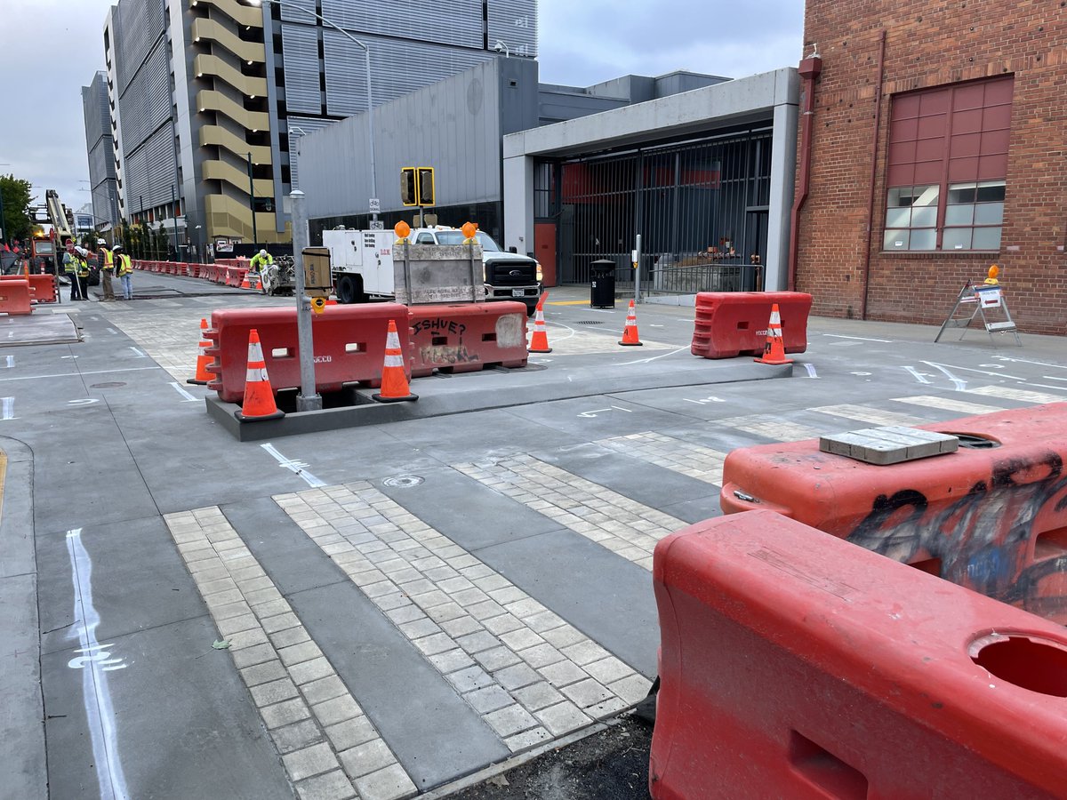 prinzrob's tweet image. A real-deal, concrete car diverter is going in on Horton at 53rd St in Emeryville right now. It doesn’t make up for the new 2k-space parking garage shown in the background, but it helps!