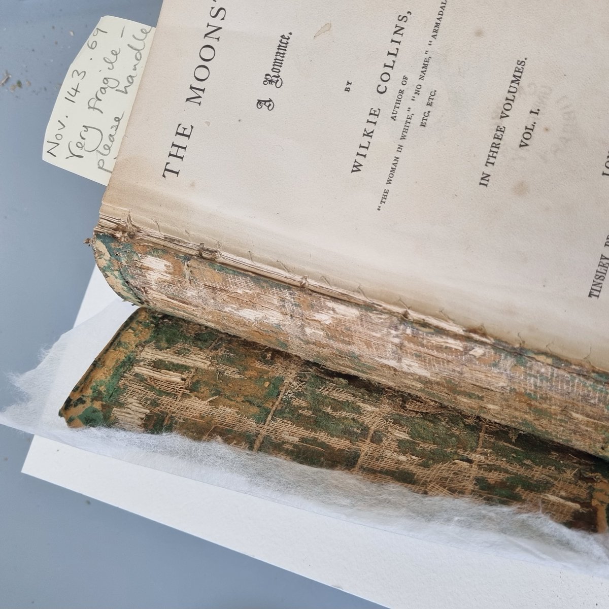 theUL's tweet photo. Some behind-the-scenes photos of ‘The Moonstone’ undergoing treatment by CUL Conservator Emma Nichols to share with you today! You can see ‘The Moonstone’, in our exhibition ‘Murder by the Book’. #CULConservation
#BookAndPaperConservation #BookConservation #MurderByTheBook https://t.co/wwfTWJ2iAL