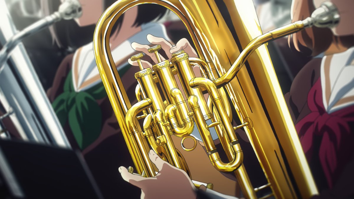 Yuyucow's tweet image. The girl that catches Kumiko's eye the most is the golden euph player the staff used to pull off that trick in the prologue. We know she's a first-year by the red. She plays a golden instrument, and by her side there's silver euph third year just like Asuka. The cycle continues