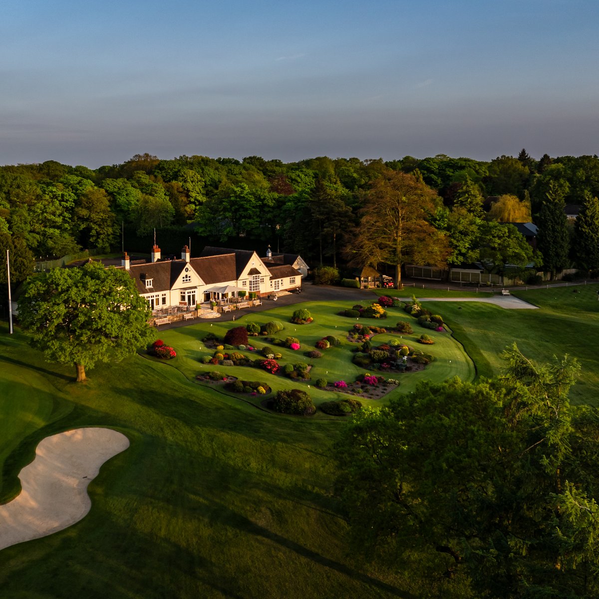 LittleAstonGolf's tweet photo. Sunset across the clubhouse with the putting green still soaking up a few evening rays. https://t.co/CbVQECRvO8
