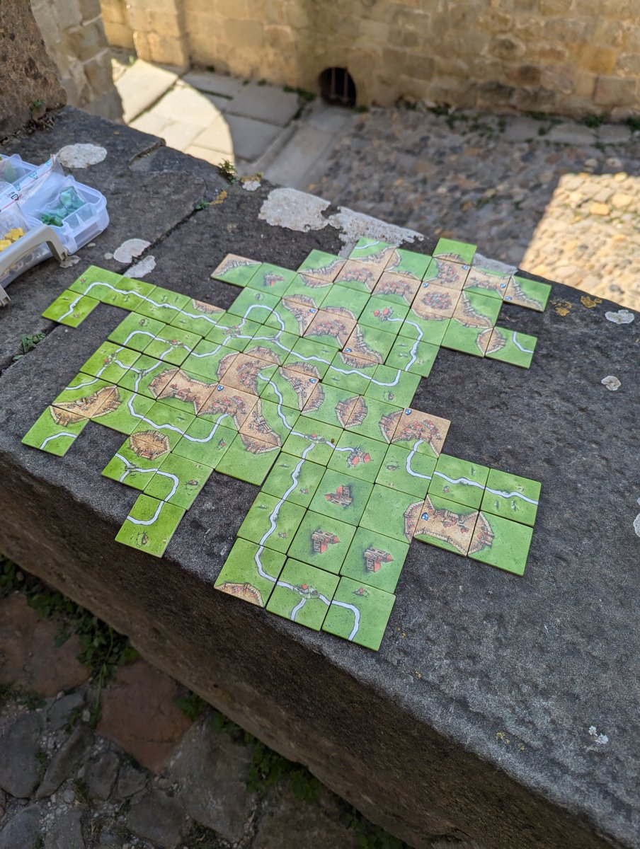 When the opportunity affords itself to play Carcassonne in Carcassonne, you go ahead and find yourself a castle wall and you take it. The mantra was "if it stays, it plays" a few tiles hung precariously at the end